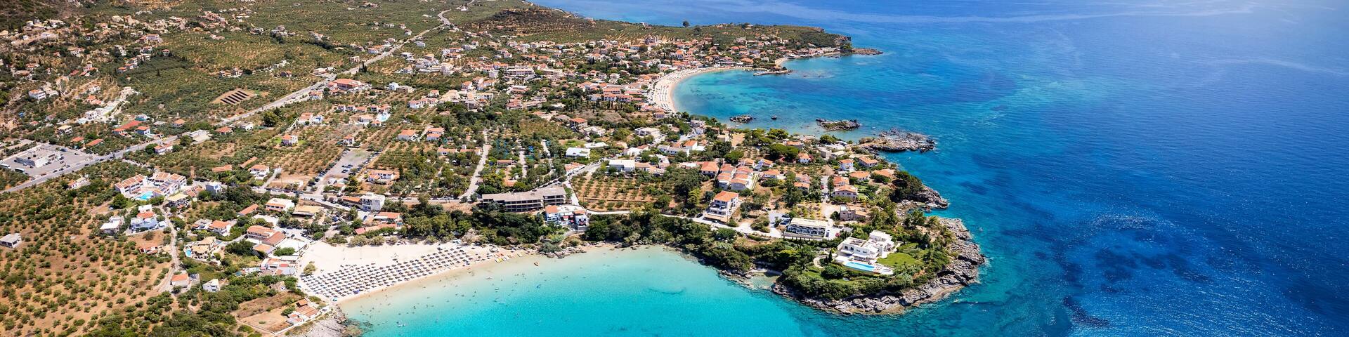 Panoramic aerial view of the beaches of Kalogria and Stoupa, Messenia, Greece, with turquoise shining sea during summer time