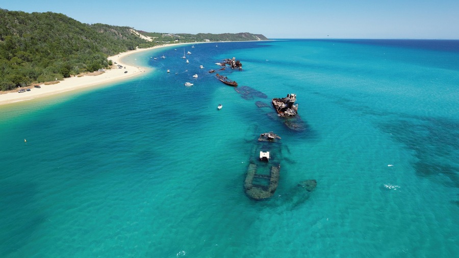 Tangalooma which includes tropical scenes, a beach and landscape views