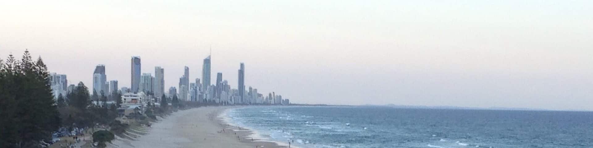 A beach with a city skyline in the background.