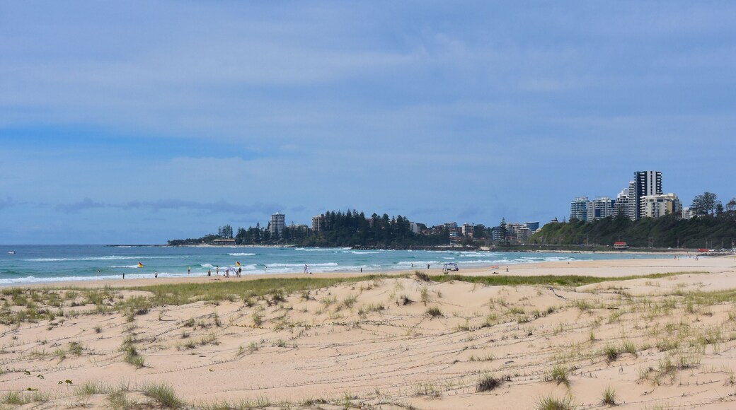 View of Coolangatta from Tugun Esplanade. People relaxing and sunbathing on Kirra Beach.