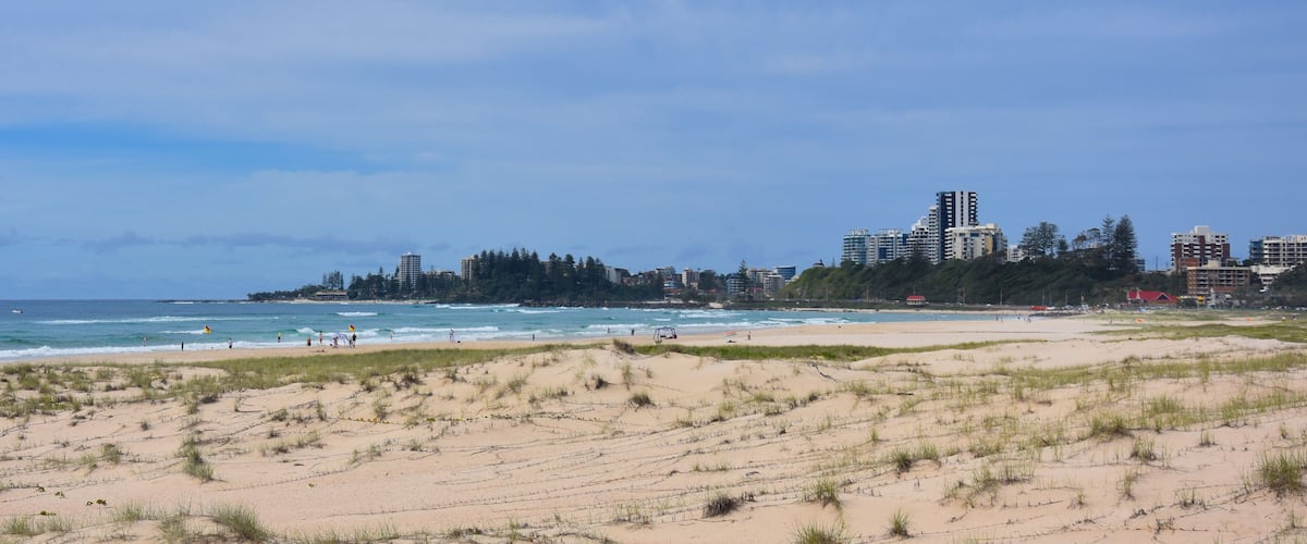 View of Coolangatta from Tugun Esplanade. People relaxing and sunbathing on Kirra Beach.