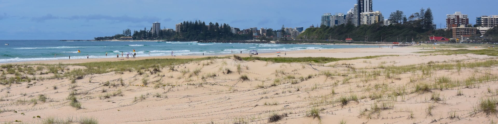 View of Coolangatta from Tugun Esplanade. People relaxing and sunbathing on Kirra Beach.