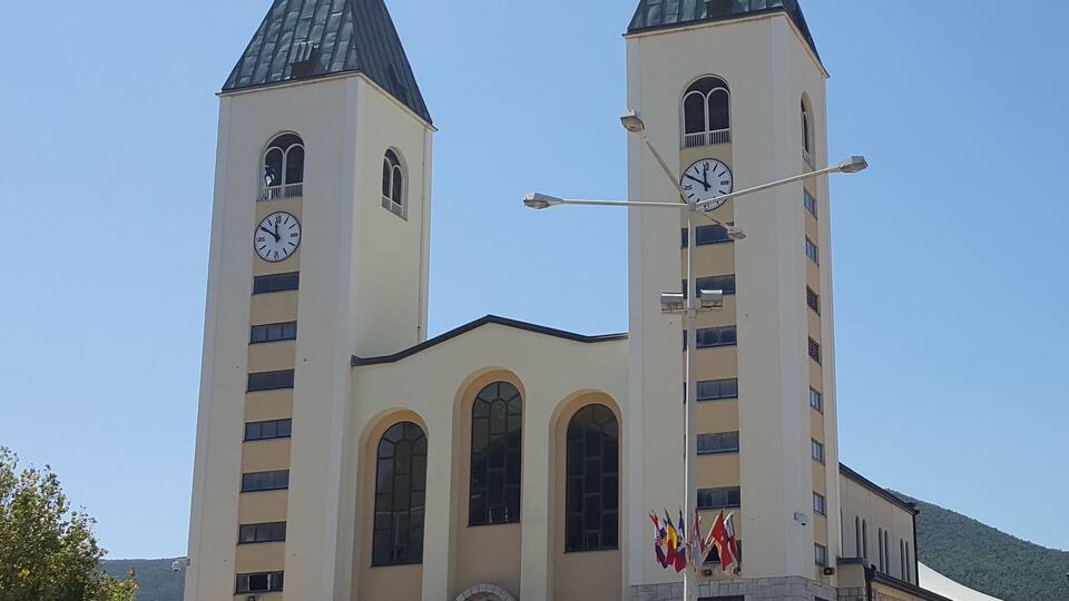 A church with two towers and a clock on each.