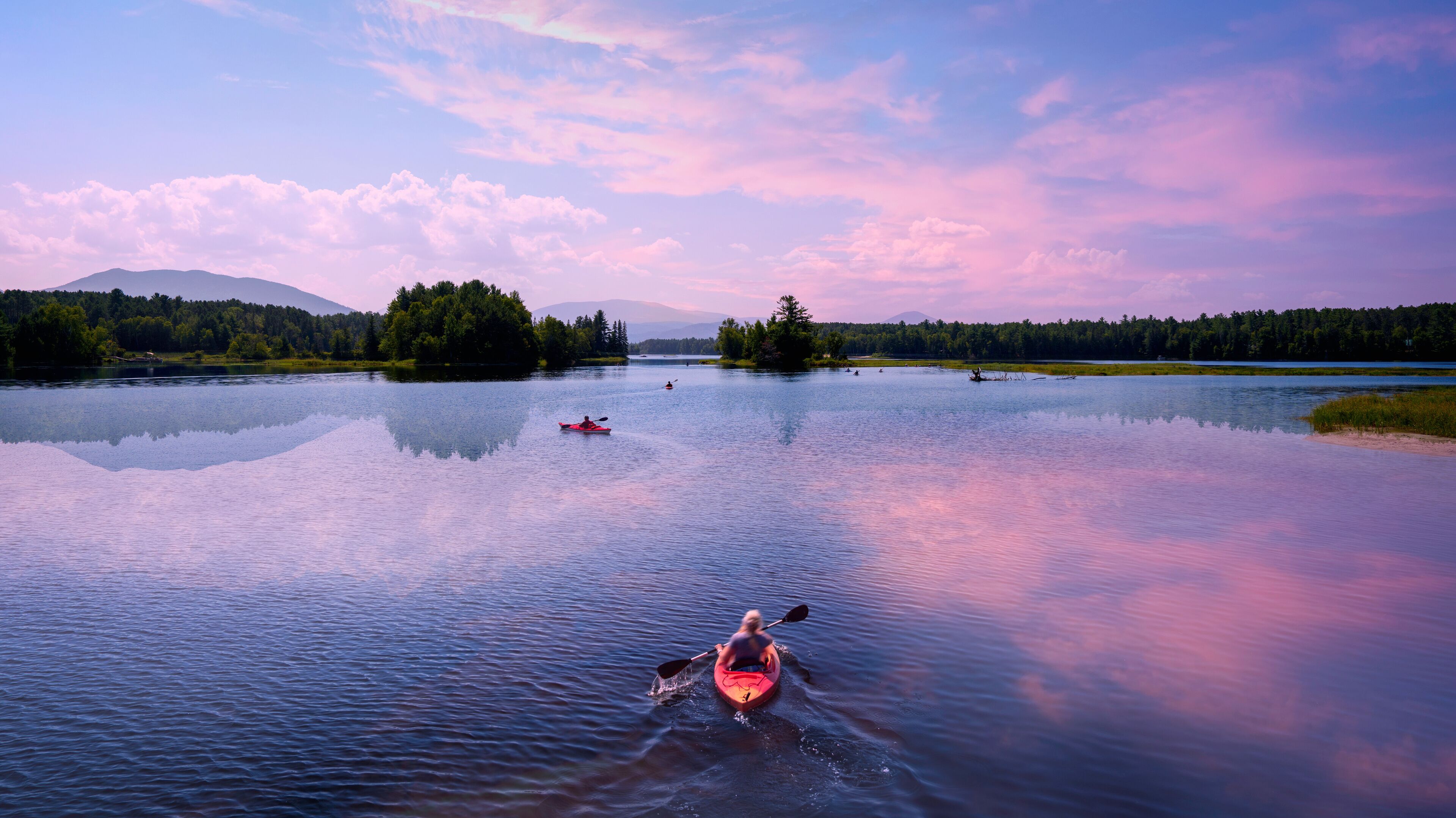 Early autumn sunrise landscape over Flagstaff Lake in Maine with water reflections of the mountains and pine forests, a tranquil popular place for canoeing in the heart of New England