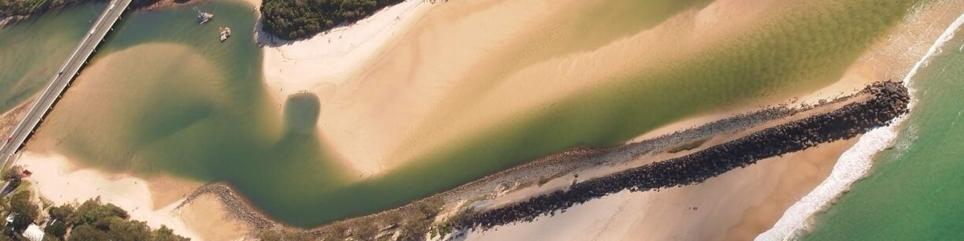 shoreline of GOLD COAST showing a foot path extending thru the Beach