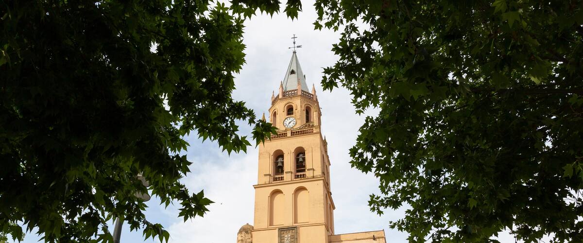 A church with a tall bell tower and a clock.