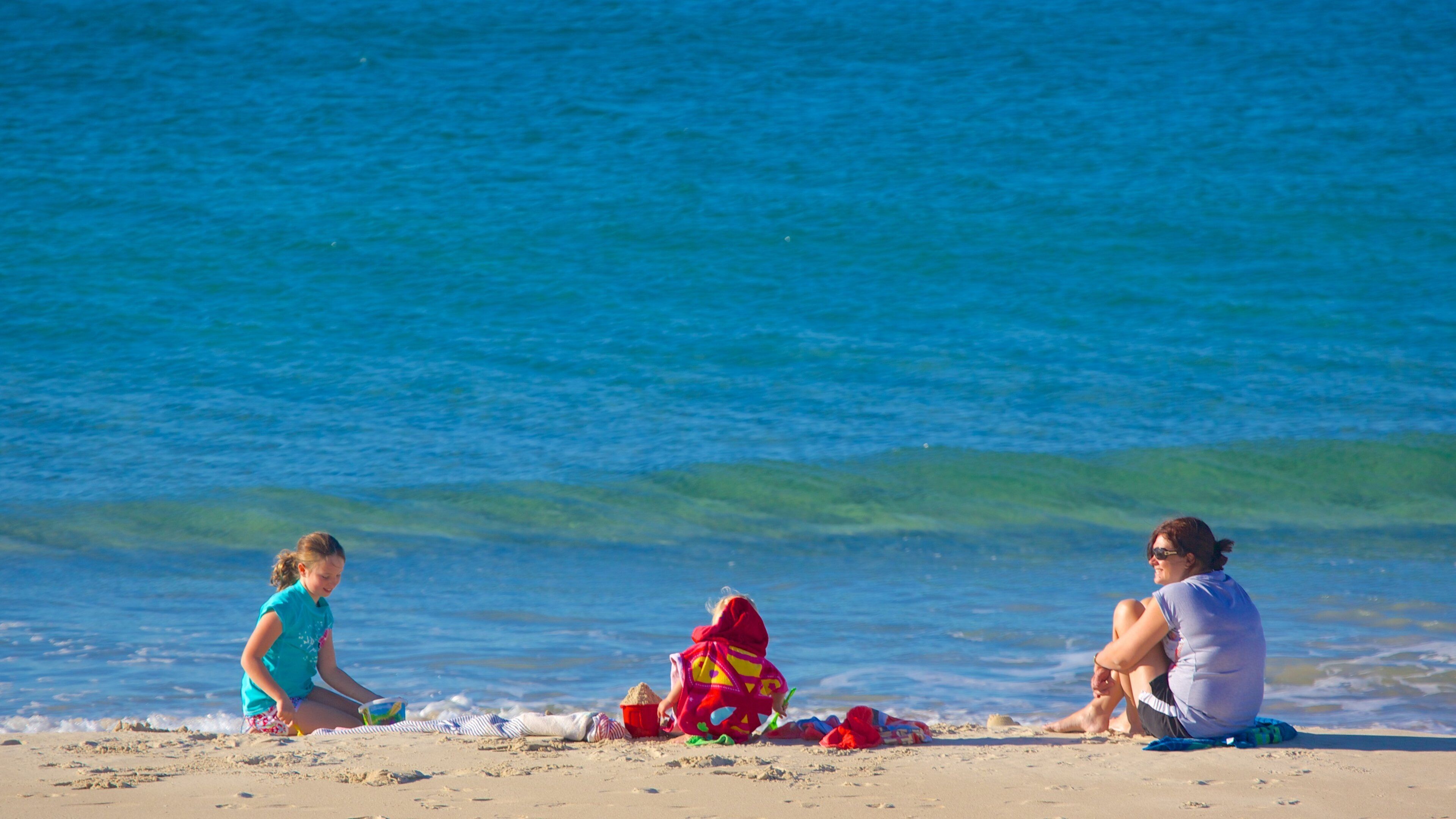 Kings Beach showing a beach and a coastal town as well as a family