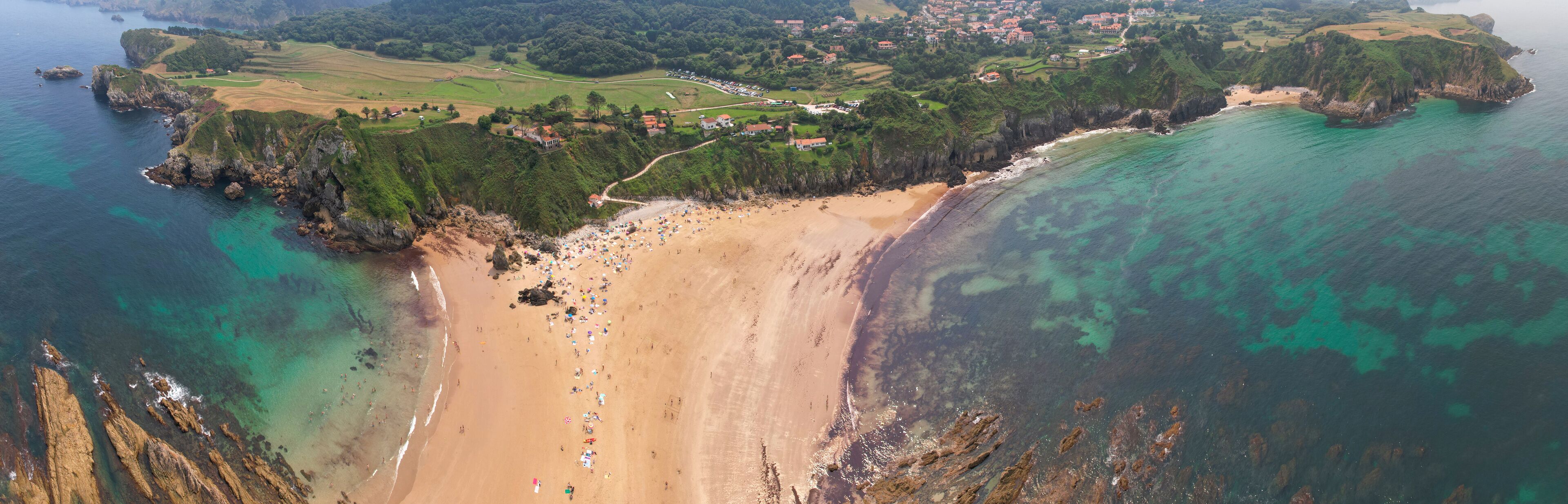Panoramic aerial view of Amio Beach on sunny summer day. Pechon, Cantabria, Spain.