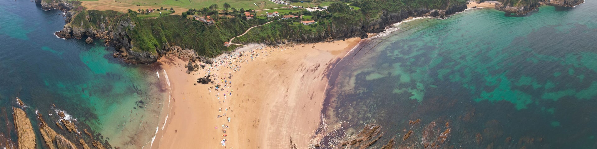 Panoramic aerial view of Amio Beach on sunny summer day. Pechon, Cantabria, Spain.