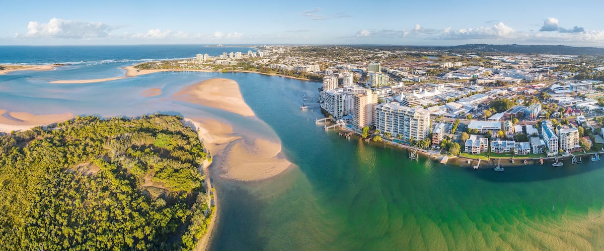 Panoramic aerial view of mangroves and real estate along the banks of the Maroochy River in Queensla