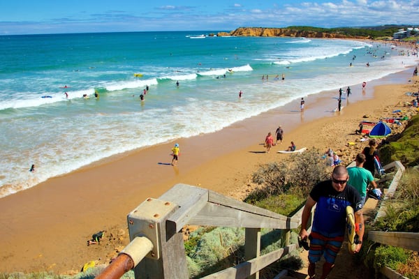 Torquay which includes a bay or harbour and a beach as well as a large group of people