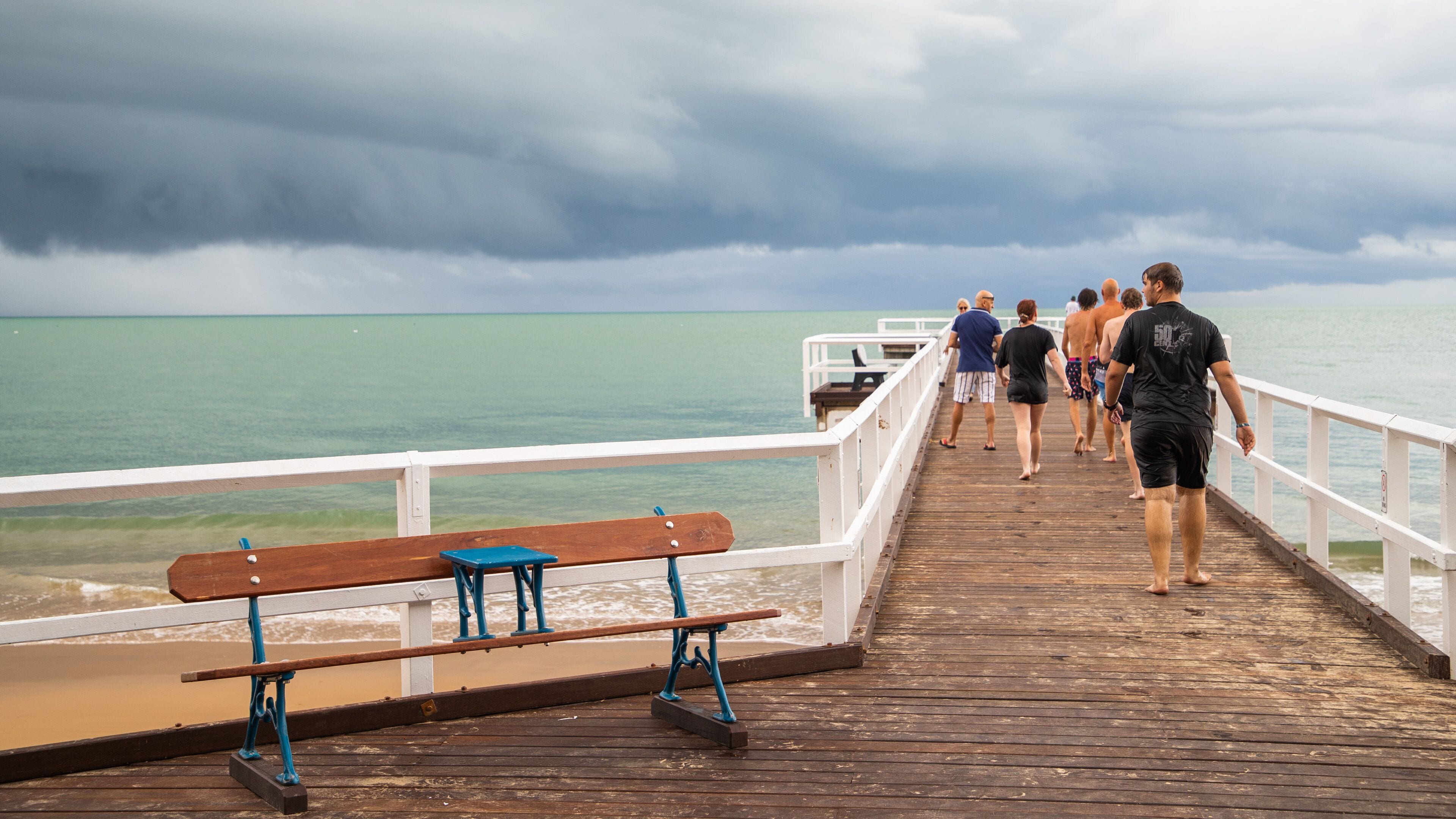 Torquay which includes general coastal views as well as a small group of people