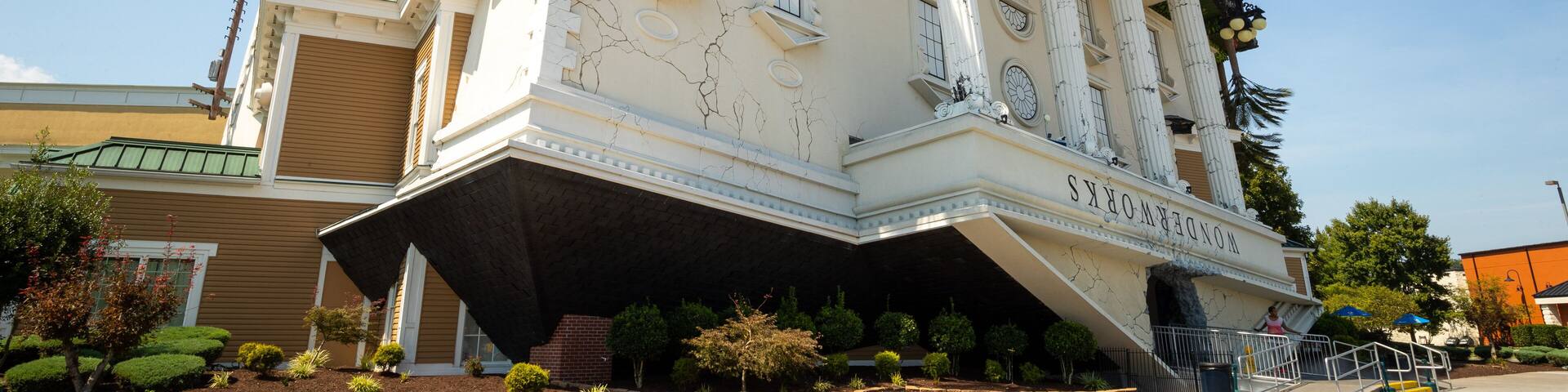 A building with a unique architectural design, featuring a sloped roof and columns.
