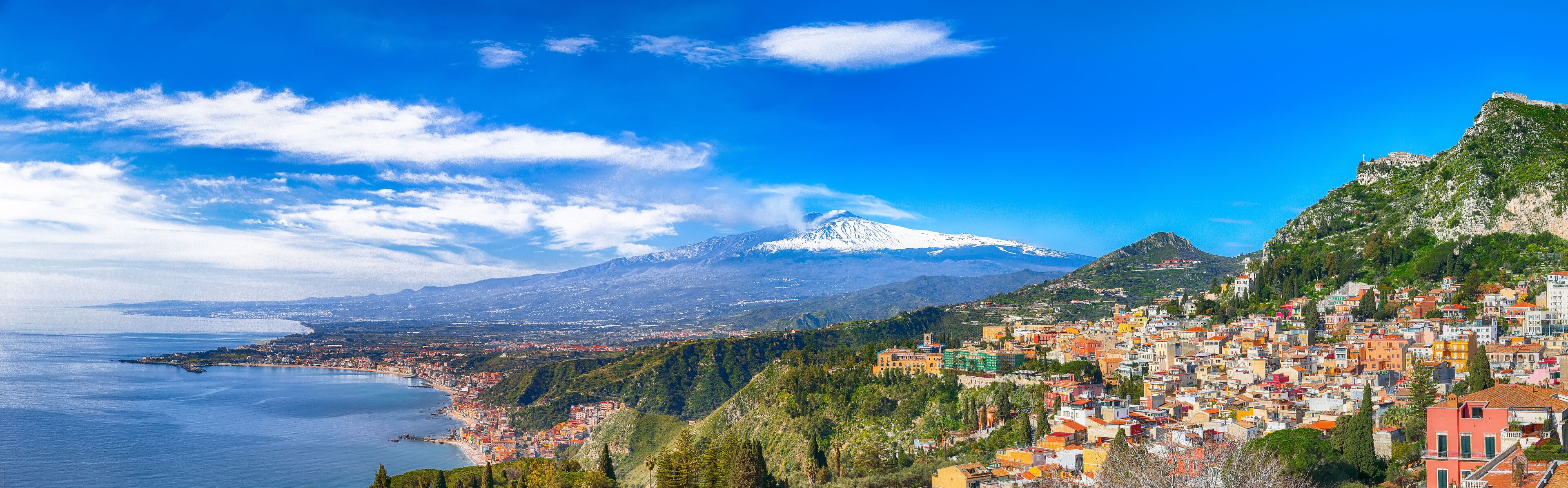 Aquamarine blue waters of sea near Taormina resorts and Etna volcano mount