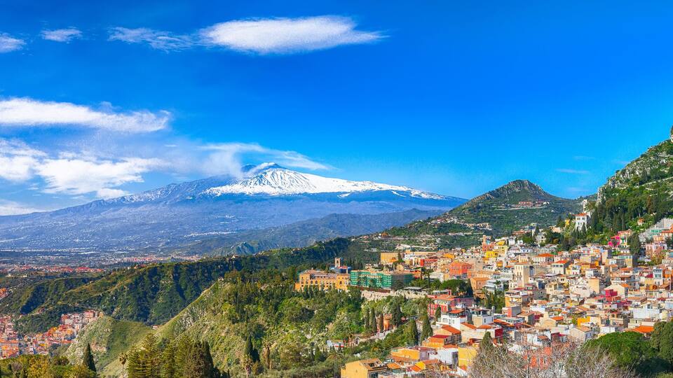 Aquamarine blue waters of sea near Taormina resorts and Etna volcano mount