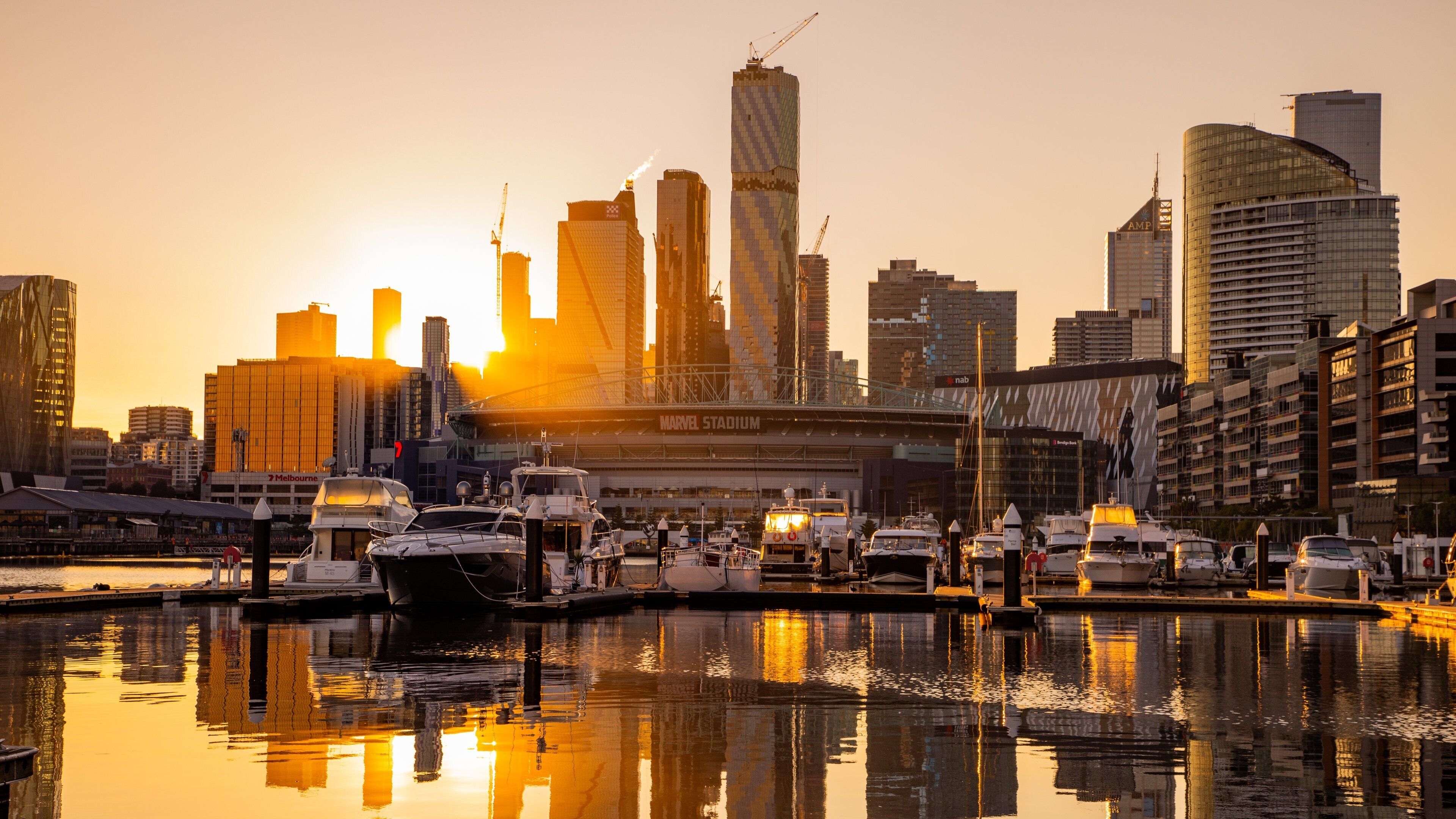Docklands which includes a sunset, a bay or harbor and a city