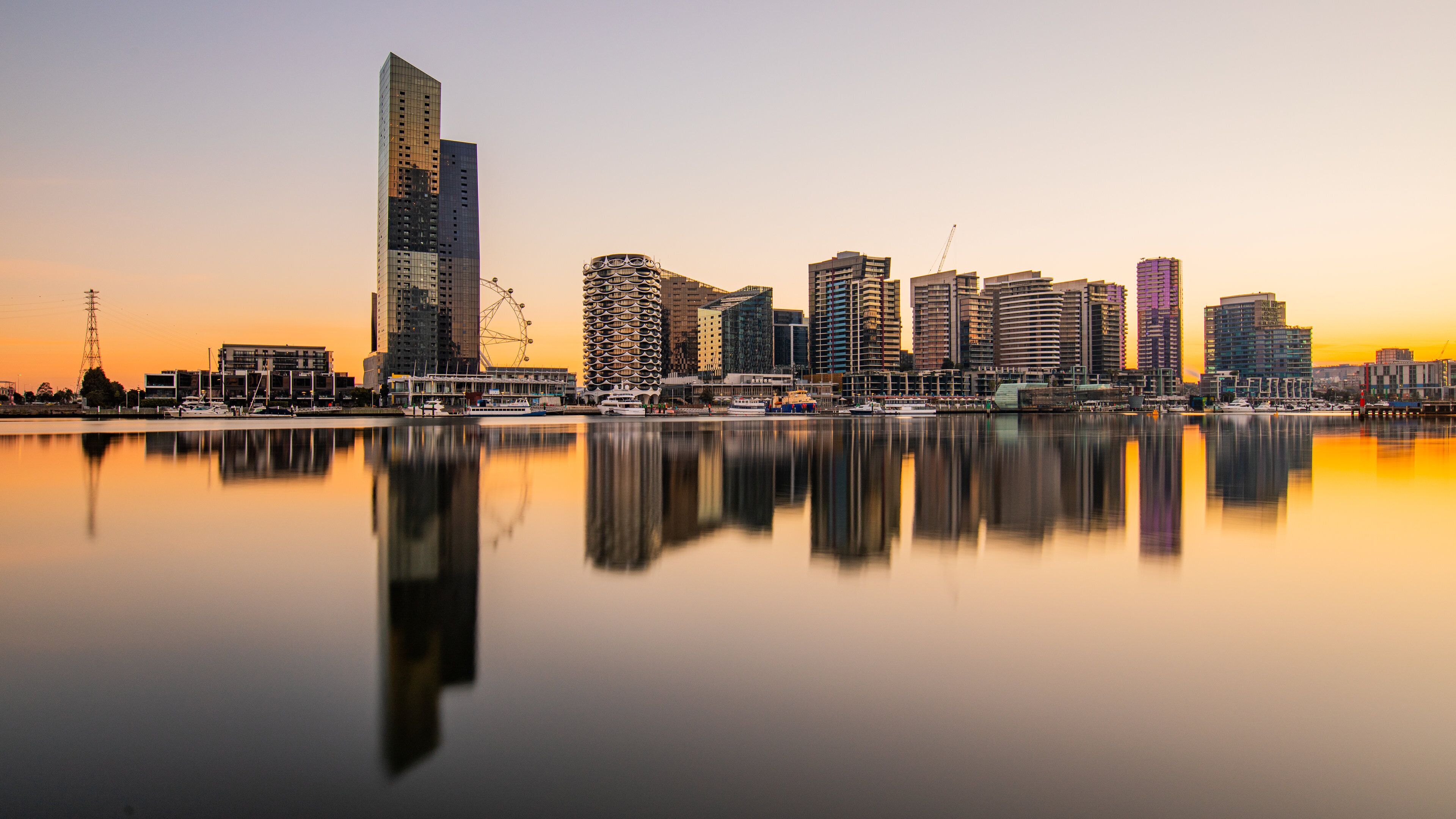 Docklands featuring a sunset, a bay or harbor and a city