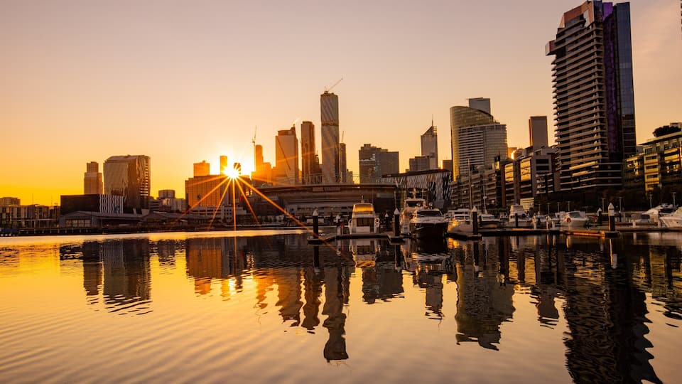 Docklands showing a city, a sunset and a bay or harbor