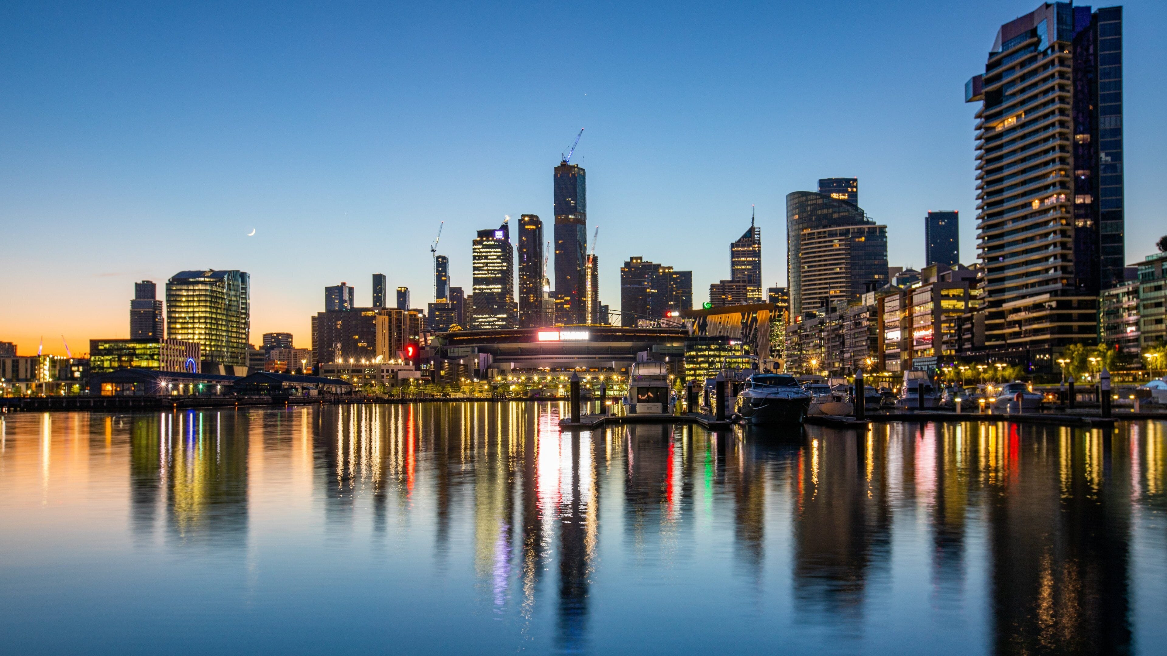 Docklands showing a sunset, a bay or harbor and night scenes