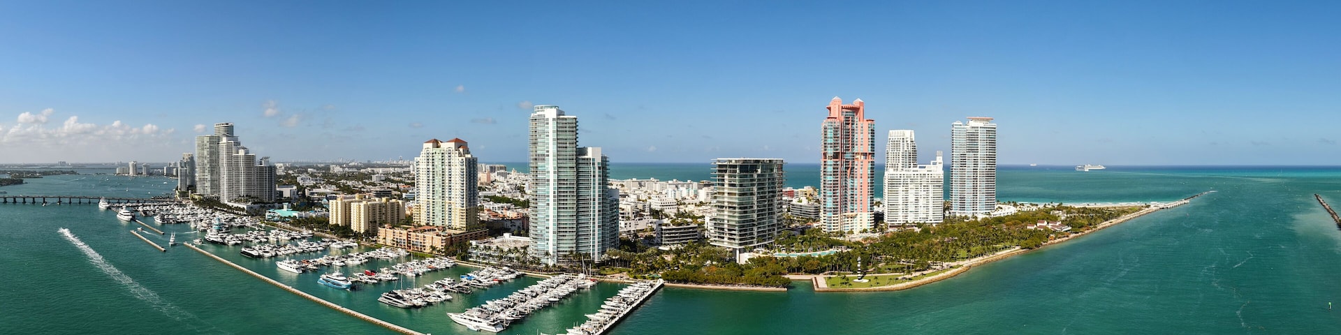 Panorama of Miami skyline and Biscayne Bay. Panoramic cityscape with coastal skyscrapers. Scenic view of Miami Beach from above. Drone captures Fisher Island and waterfront.