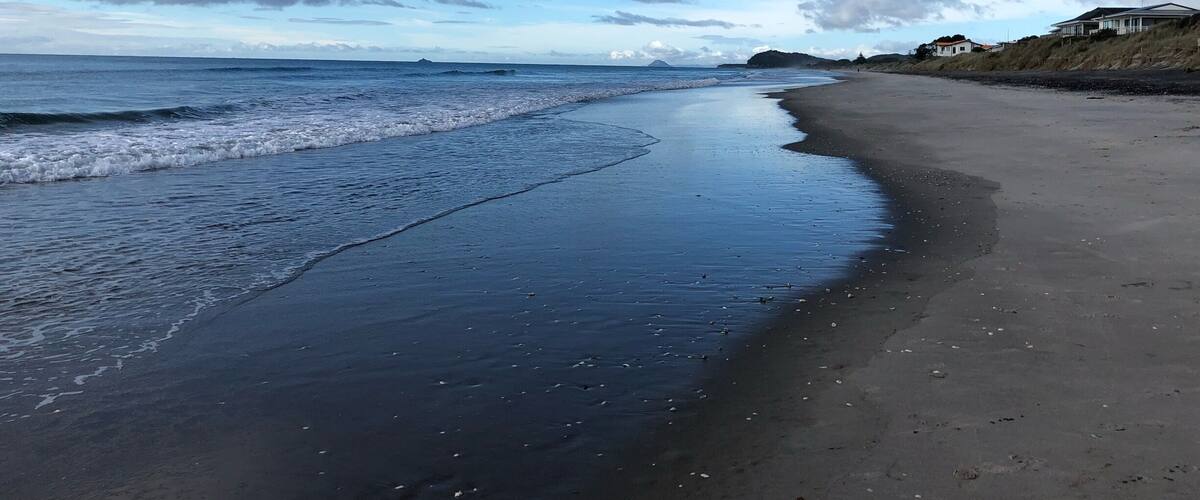 Beautiful western bay of plenty beach in waihi overlooks Mayor and Matakana island