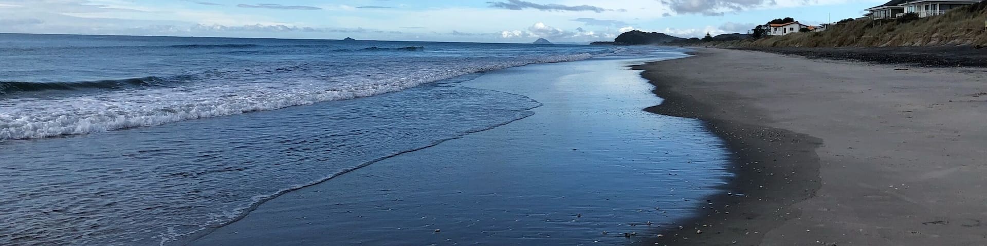 Beautiful western bay of plenty beach in waihi overlooks Mayor and Matakana island