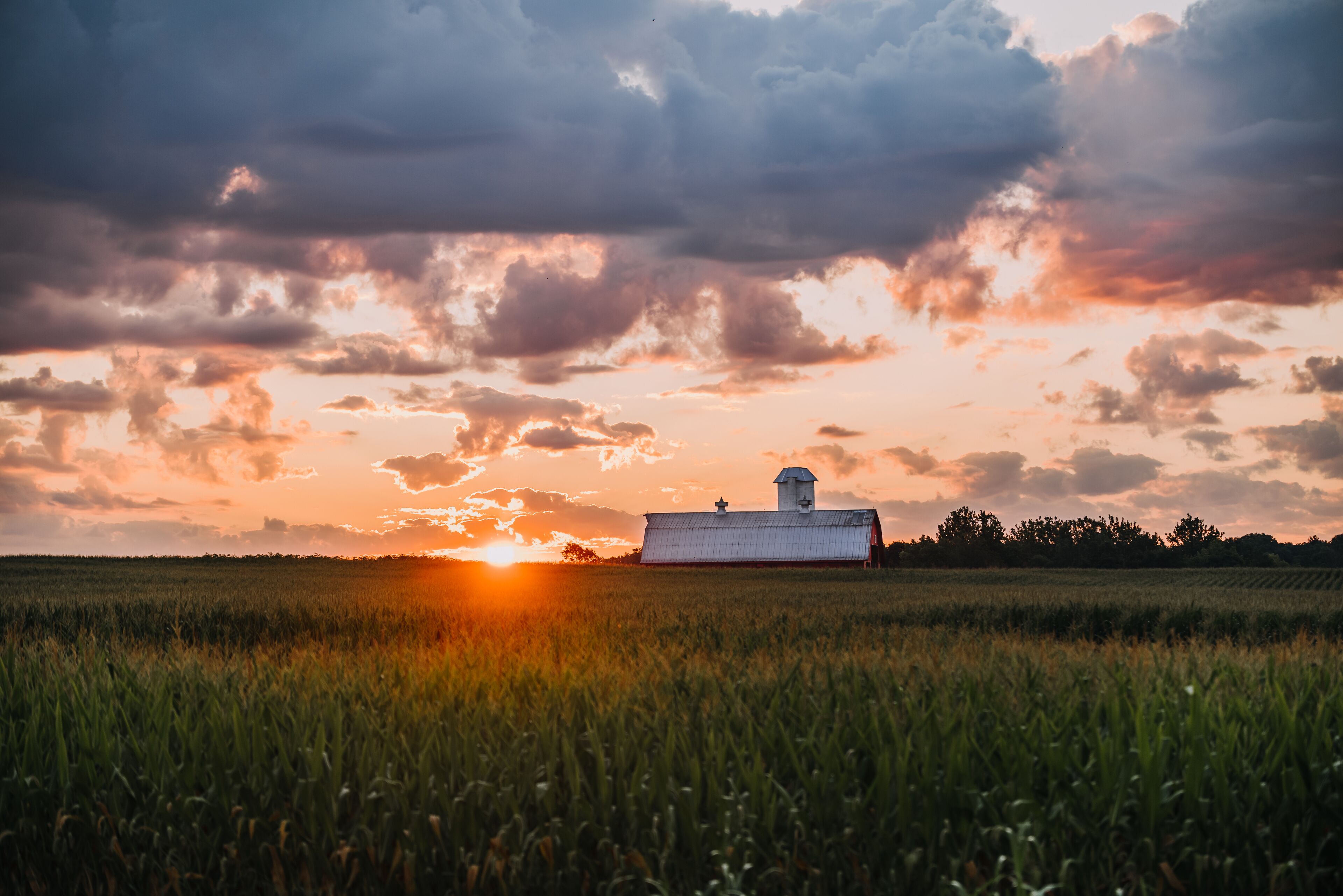 Indiana sunrise over the farm with a red barn