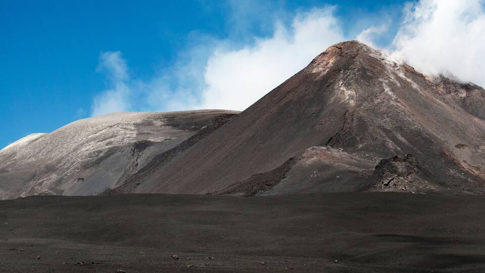 A rugged mountain peak with a clear sky.