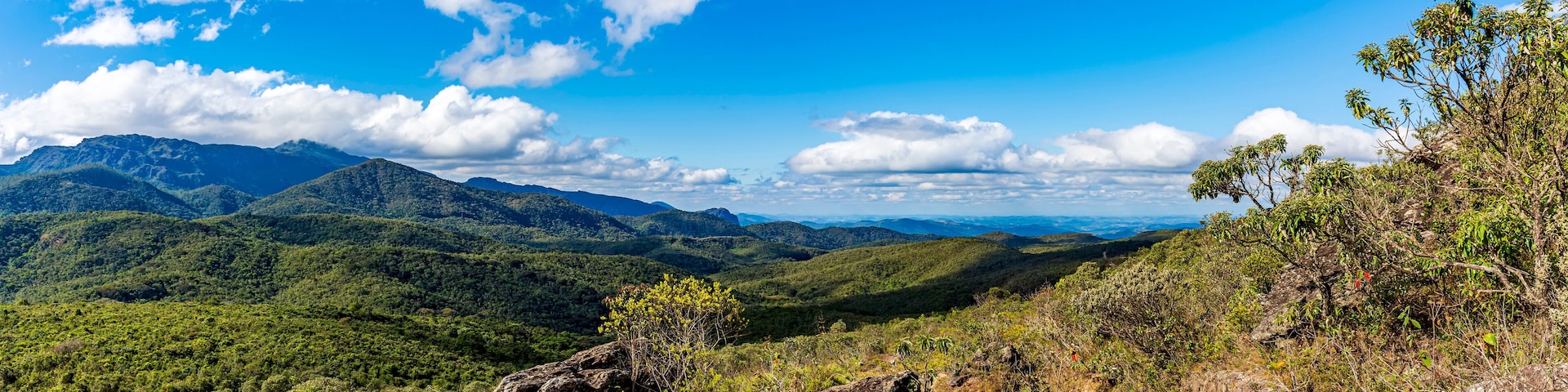 A mountainous landscape with a clear sky and a dirt path.