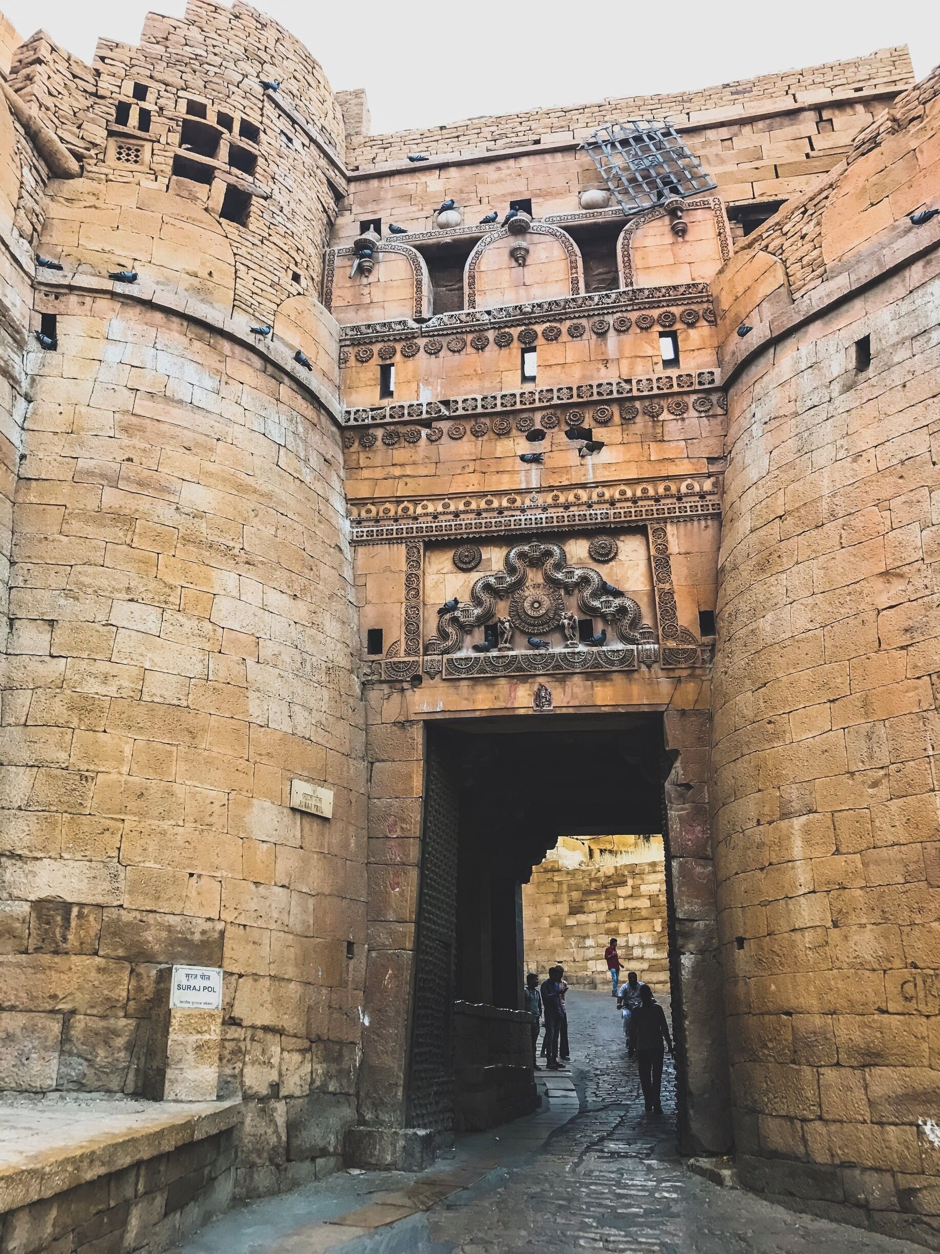 #InStone 
Entering the Sonar Kella/Golden Fortress of Jaisalmer. Its a one of the forts where still families of different castes in Rajasthan lives in small homes and their main source of livelihood is handicrafts and hotels and tourism. Almost every other home has been converted to small rooftop hotels. For us Bengalis, visiting the Sonar Kella at least once in life is a child's dream come true. Each and every resident in this Kila and tour guides appreciates the fact that the tourism surrounding this Fort and rather whole of Jaisalmer boomed only after 1974, after the timeless movie 'Sonar Kella' by the world renowned and late Bengali director 
Satyajit Ray. The more reason why I said, its a dream come true for every Bengali to be here as we've grown up watching this movie and still enjoy it time and again. Such majestic and gorgeous is the fort filled with heartwarming souls. We shall be back again.❤️ #goldenfortress #sonarkella #jaisalmer #rajasthandiaries