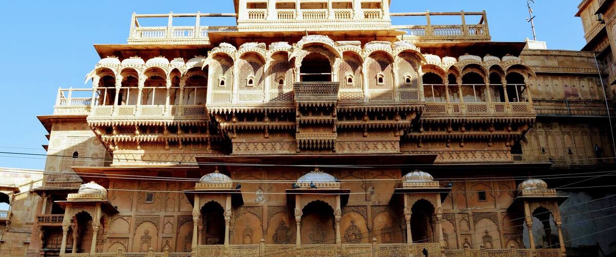 A multi-tiered, ornate building with intricate carvings and balconies.