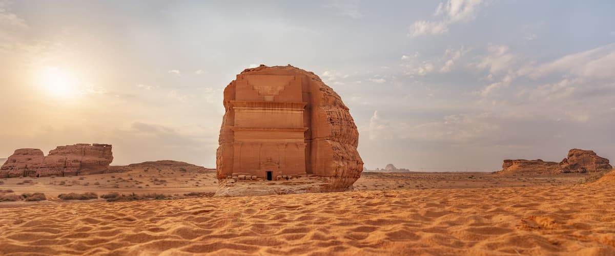 Tomb Lihyan Son of Kuza or Qasr al-Farid at Hegra, Saudia Arabia - most popular landmark in Mada'in Salih archaeological site, sandy desert landscape, morning sun background - high resolution panorama