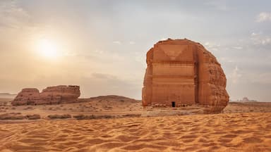 Tomb Lihyan Son of Kuza or Qasr al-Farid at Hegra, Saudia Arabia - most popular landmark in Mada'in Salih archaeological site, sandy desert landscape, morning sun background - high resolution panorama