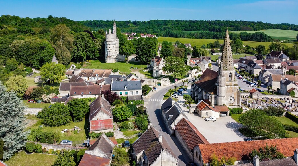 Church Saint André of Septmonts in Aisne, Picardie, France - Gothic flamboyant religious building with a bell tower lined with hooks and crowned with a stone spire
