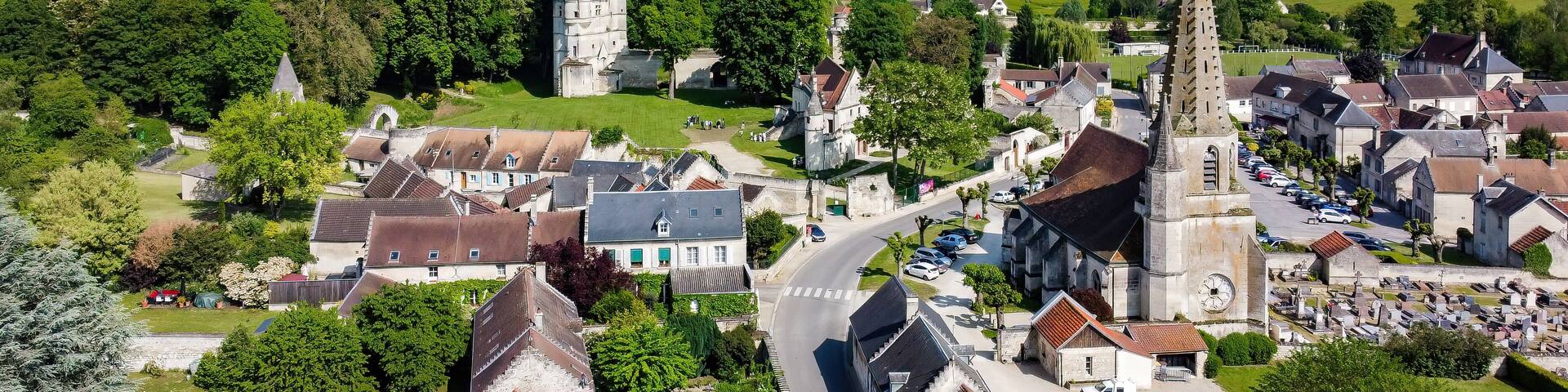 Church Saint André of Septmonts in Aisne, Picardie, France - Gothic flamboyant religious building with a bell tower lined with hooks and crowned with a stone spire