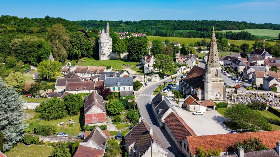 Church Saint André of Septmonts in Aisne, Picardie, France - Gothic flamboyant religious building with a bell tower lined with hooks and crowned with a stone spire