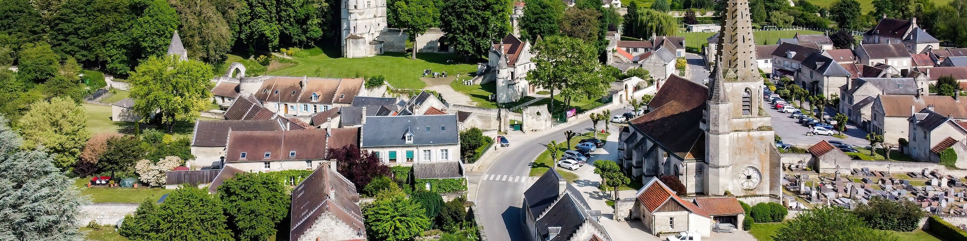 Church Saint André of Septmonts in Aisne, Picardie, France - Gothic flamboyant religious building with a bell tower lined with hooks and crowned with a stone spire