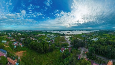 High wide drone view of fish farming floating community and surrounds in Bien Hoa on the Dong Nai river in Vietnam on sunny day