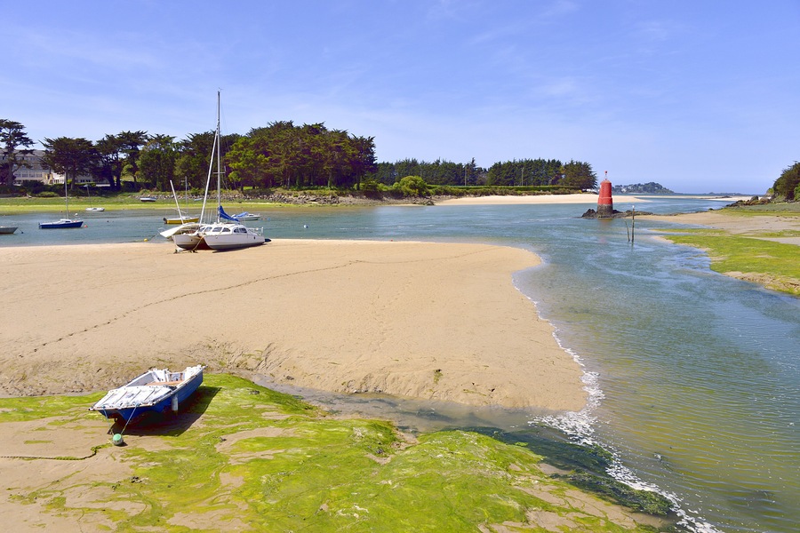 Beach in low tide with boats at Locquirec