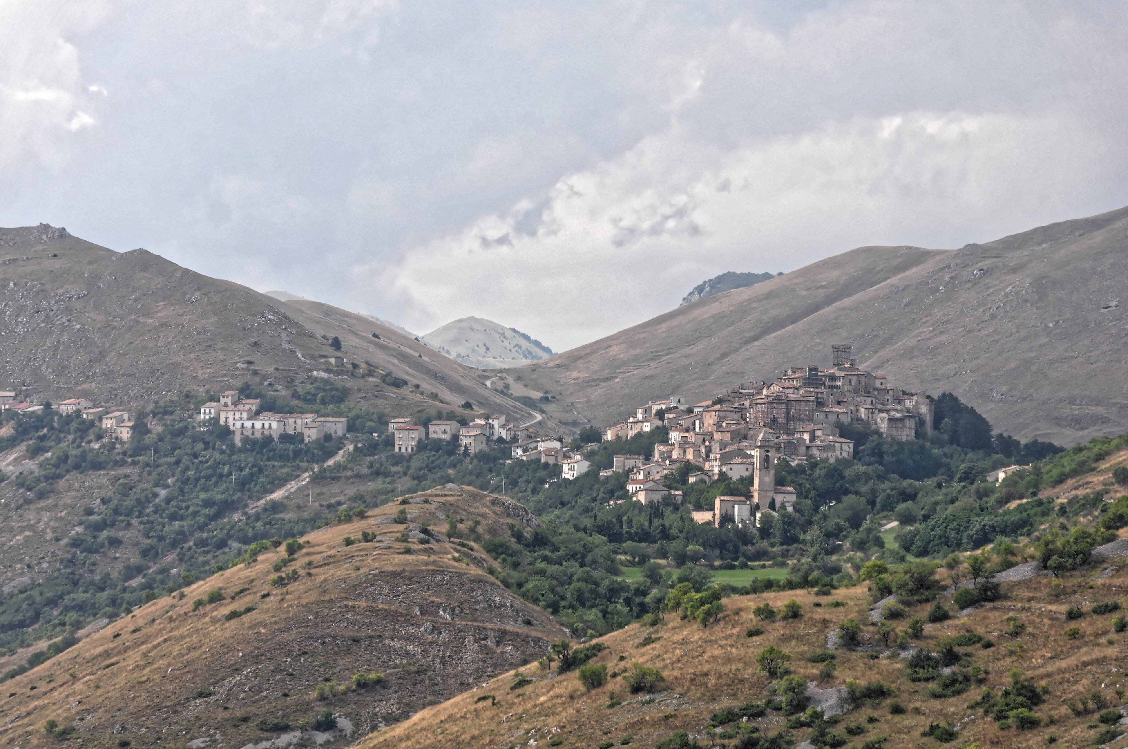 A mountainous village with buildings nestled among the hills.
