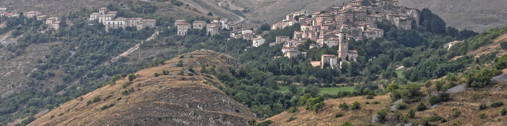 A mountainous village with buildings nestled among the hills.