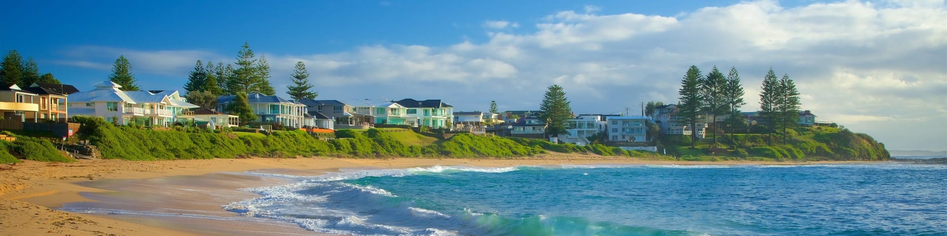 Blue Bay which includes a beach, a coastal town and general coastal views