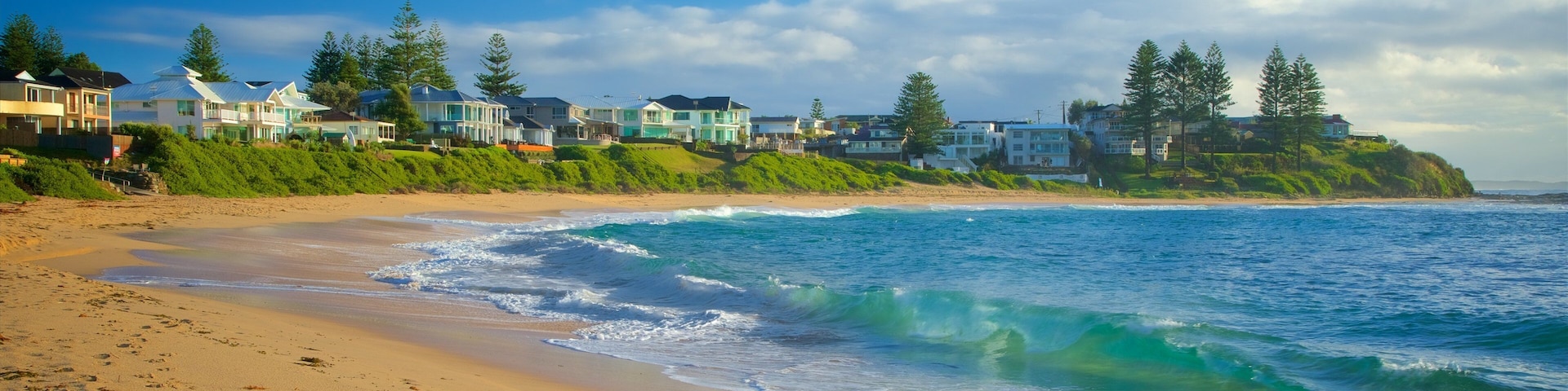 Blue Bay which includes a beach, a coastal town and general coastal views