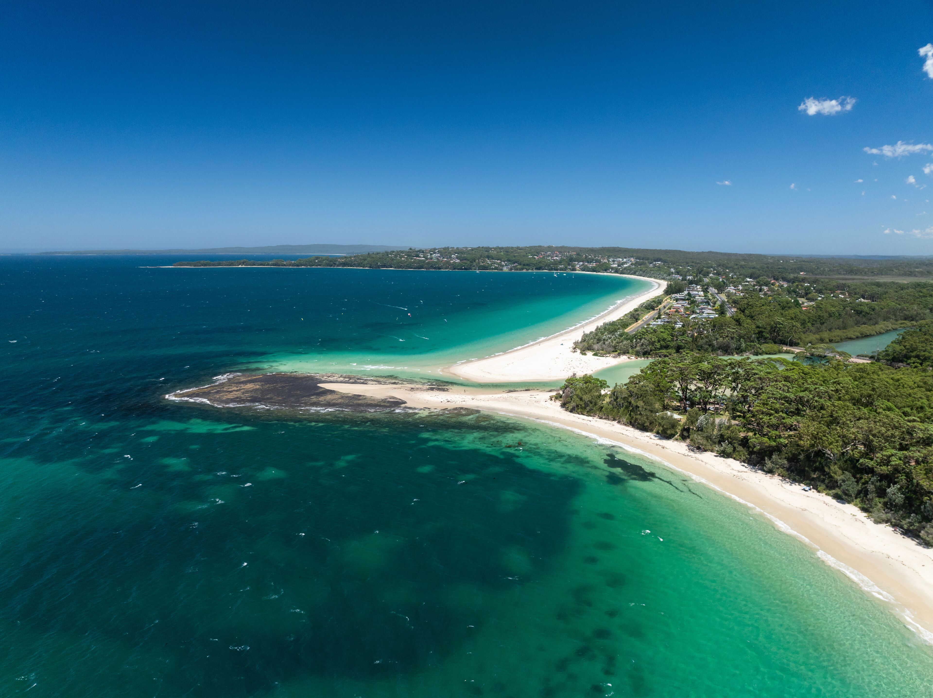 High angle aerial drone view of Huskisson Beach and Collingwood Beach in Huskisson and Vincentia, beachside suburbs in Jervis Bay Territory and on the South Coast of New South Wales, Australia.