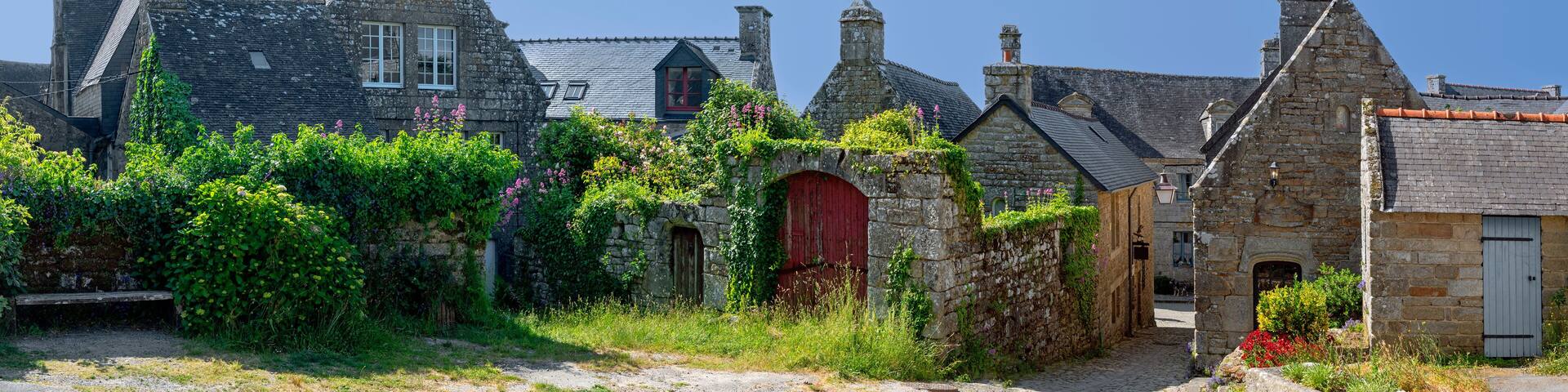 panoramic view of the center of the medieval village Locronan in Brittany with historic stone houses, France