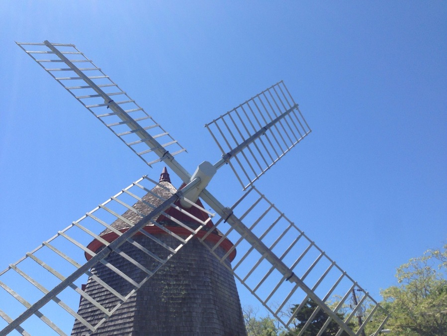 This is the Eastham Windmill in Eastham, MA on Cape Cod. It is the oldest windmill on Cape Cod, built in 1630. Every June there is an art festival held on the green by the windmill.