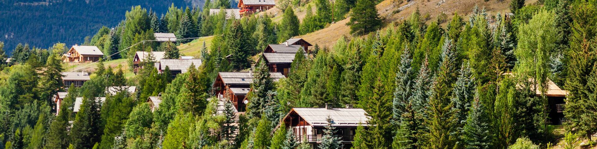 Molines-en-Queyras, Provence, France: charming mountain village, with chalet wooden houses and Queyras peaks in background, in "Alpes de Haute-Provence", near Nice