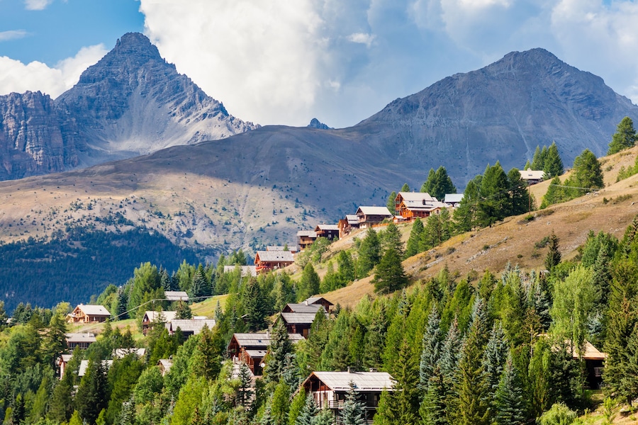 Molines-en-Queyras, Provence, France: charming mountain village, with chalet wooden houses and Queyras peaks in background, in "Alpes de Haute-Provence", near Nice