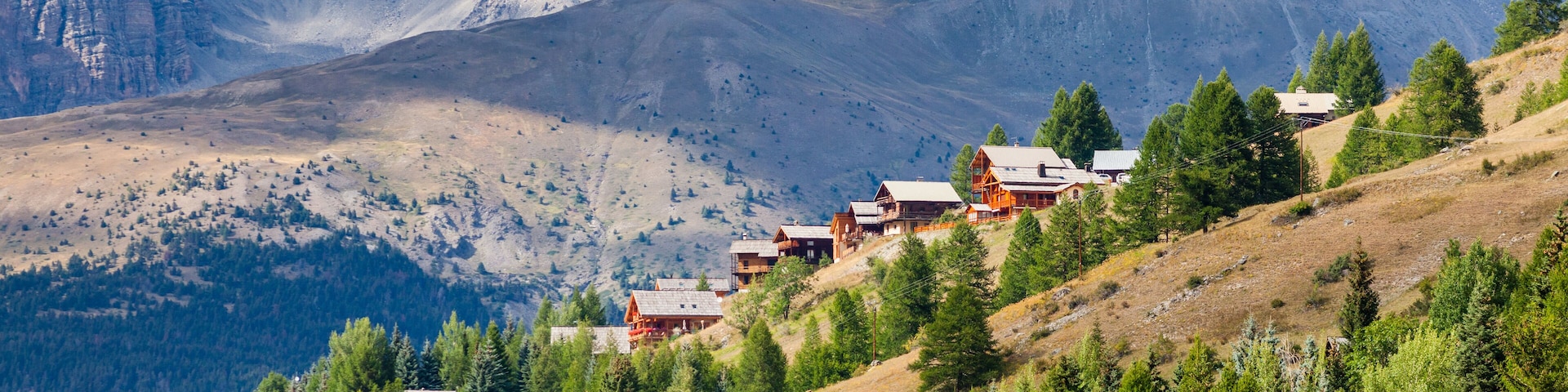 Molines-en-Queyras, Provence, France: charming mountain village, with chalet wooden houses and Queyras peaks in background, in "Alpes de Haute-Provence", near Nice