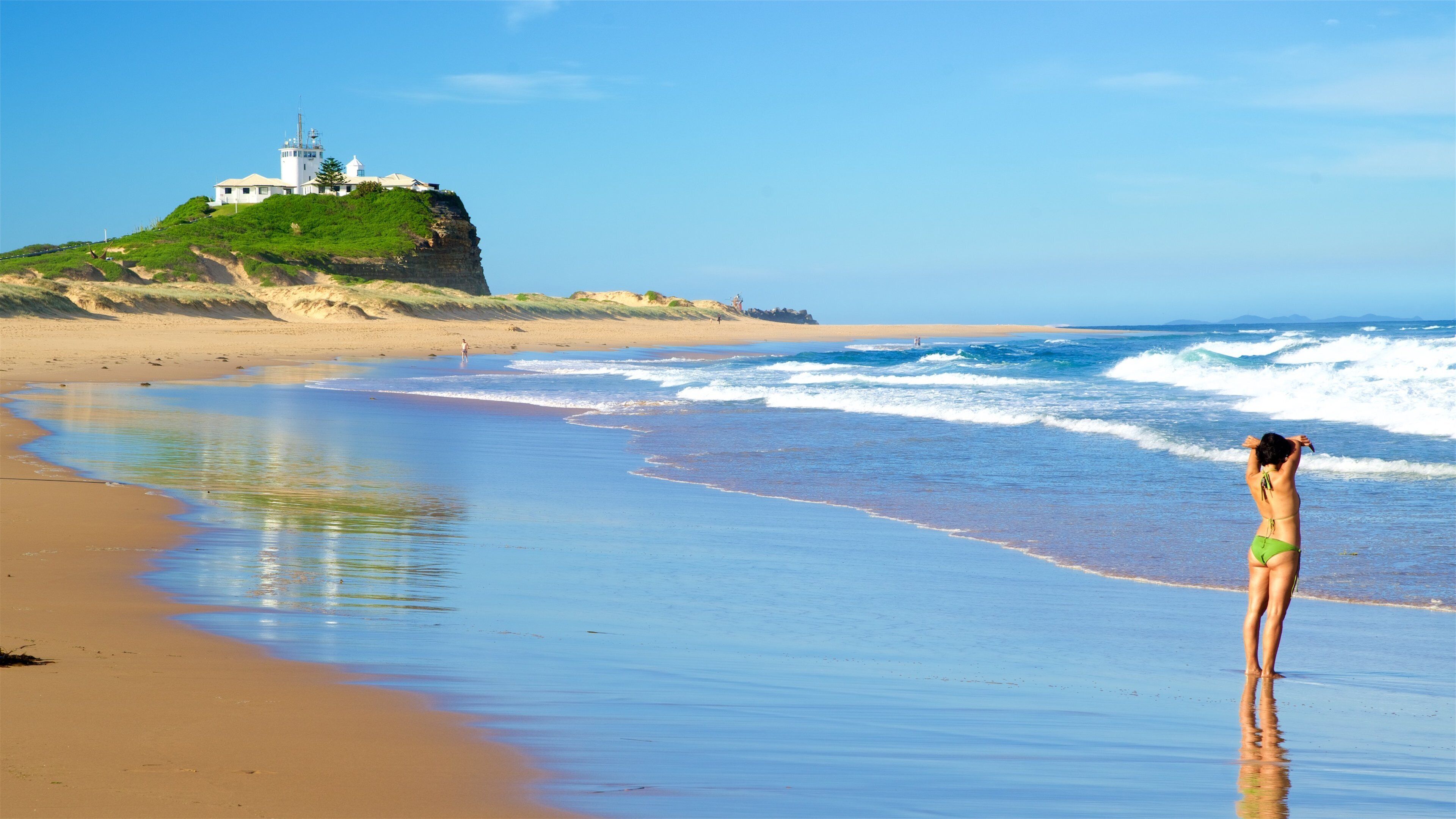 Newcastle East featuring a sandy beach and general coastal views as well as an individual femail